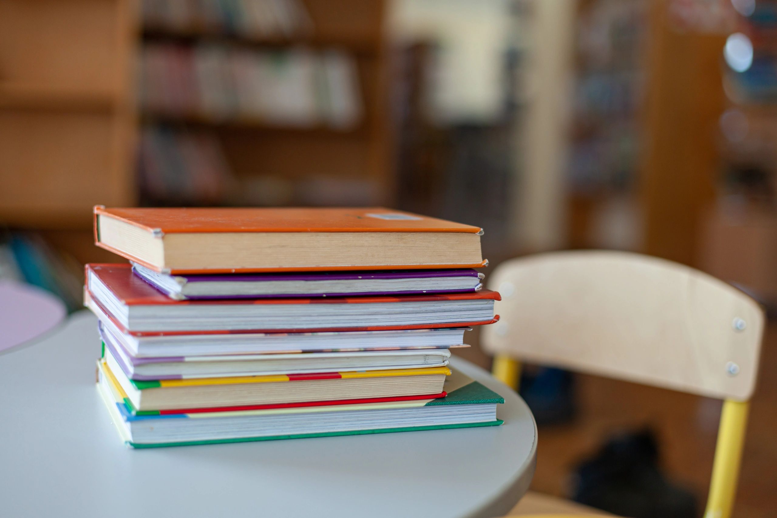 Colorful stack of hardcover books on a table